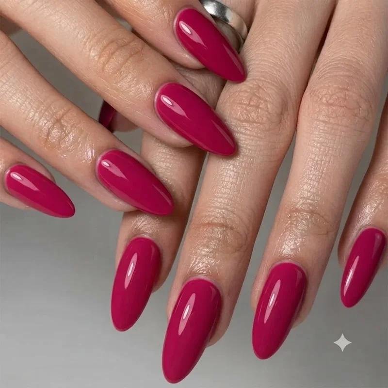 Barbie nails in solid glossy fuchsia on a medium almond shape, a classic hot pink barbiecore manicure