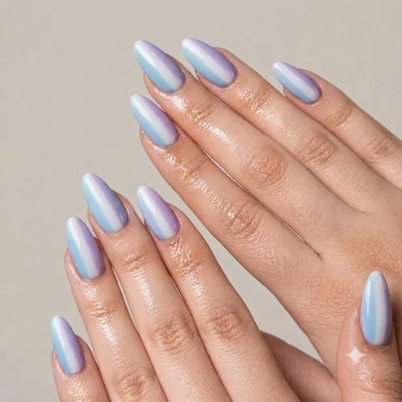 Cinnamoroll nails palette closeup showing pastel blue, soft white and lavender polish shades side by side on nails