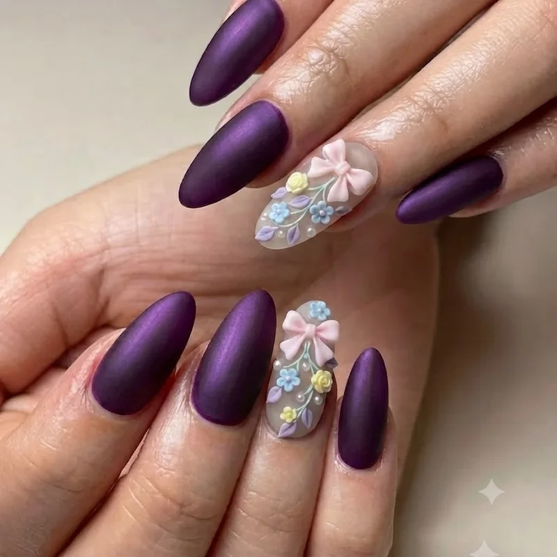 Close-up of 3D bow and floral nail art on girly nails accent design