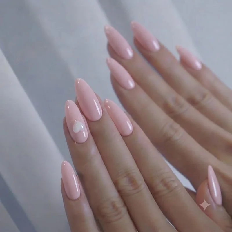Classic girly nails manicure in soft pink with a single heart accent nail