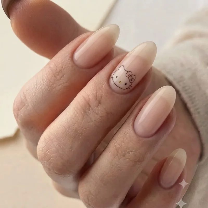 Single accent nail with minimalist Hello Kitty face design on a nude base manicure