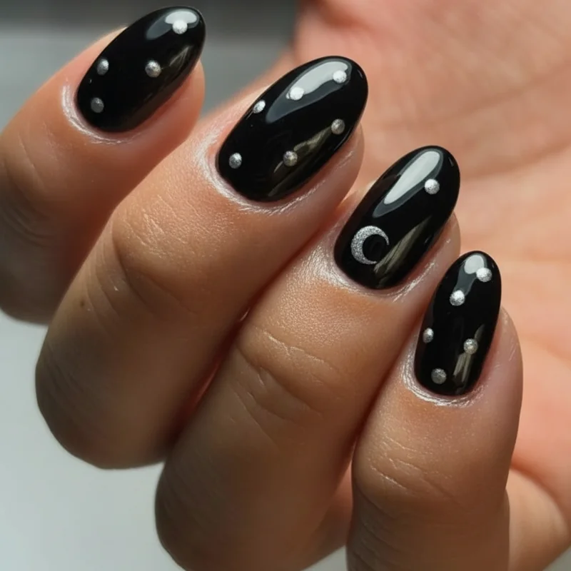Beginner goth nail designs flat lay showing black polish silver dots moon crescent and dark nail art ideas for home manicure no tools