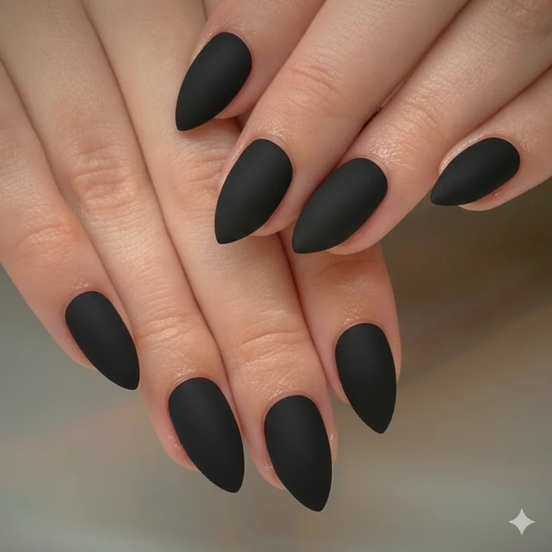 Gothic nail art tools flat lay showing black nail polish base coat matte top coat detail brush and toothpick for DIY goth manicure at home