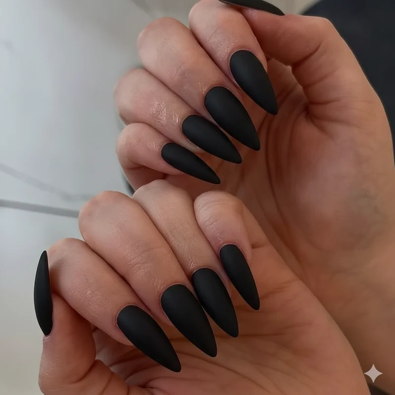 Matte black nail polish showing three thin coat coverage for streak-free dark gothic manicure finish at home without salon tools