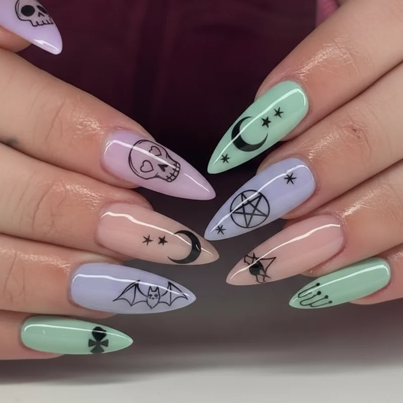 Pastel goth nail motifs including skull moon pentagram bat bow and black drip nail art detail in close-up macro shot