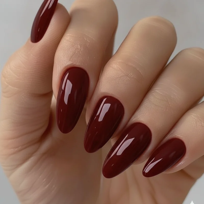 Close-up of vampy nails in deep blood red showing the seductive moody aesthetic that defines the vampy nail look in 2026