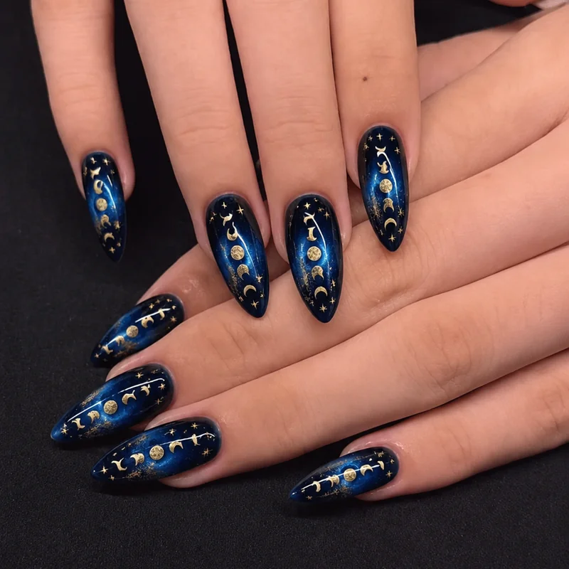 Celestial witch nails showing moon phase sequence in deep midnight blue with gold foil accents on almond shape for cosmic witchy nail aesthetic