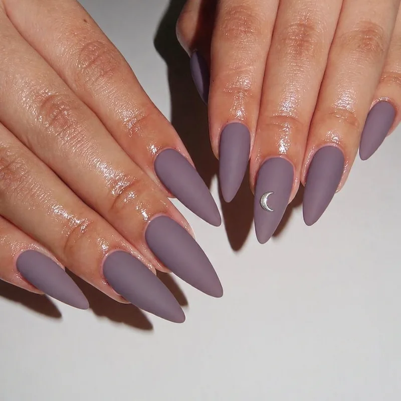 Soft minimal witchy nails in dusty mauve matte and smoky lilac with crescent accent showing everyday wearable witchy nail aesthetic for year-round wear
