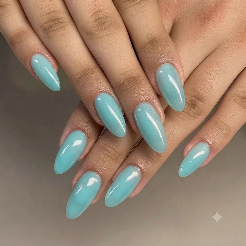 Sheer coral glazed jelly nails with light chrome finish in almond shape for summer manicure inspiration