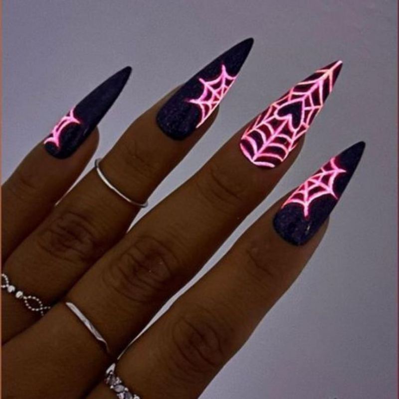 Black spiderweb pattern on white french tip Halloween manicure for almond shaped nails