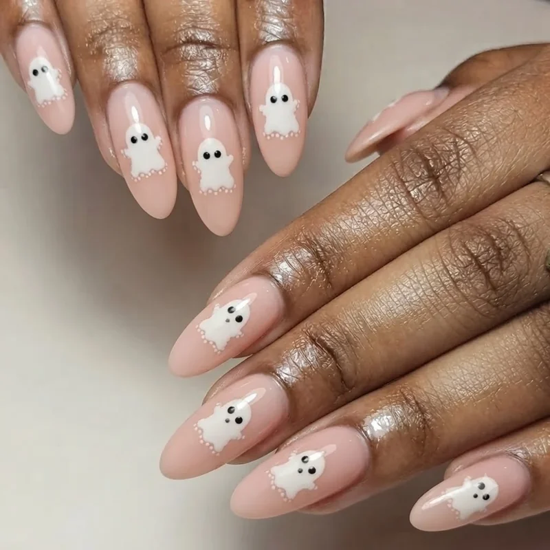 Pastel pumpkin nail art using negative space technique for cute halloween nails