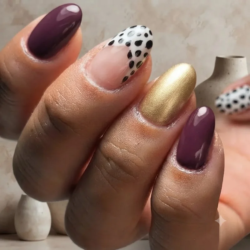 Evil Queen and Cruella de Vil disney halloween villain nails in plum gold and black white spotted pattern