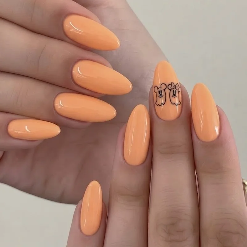 Mickey and Minnie ghost Halloween nail design with pastel pumpkin accent nail and classic black silhouette