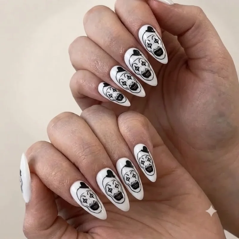 Art the Clown face paint nail art in heavy black outline on a stark white base nail