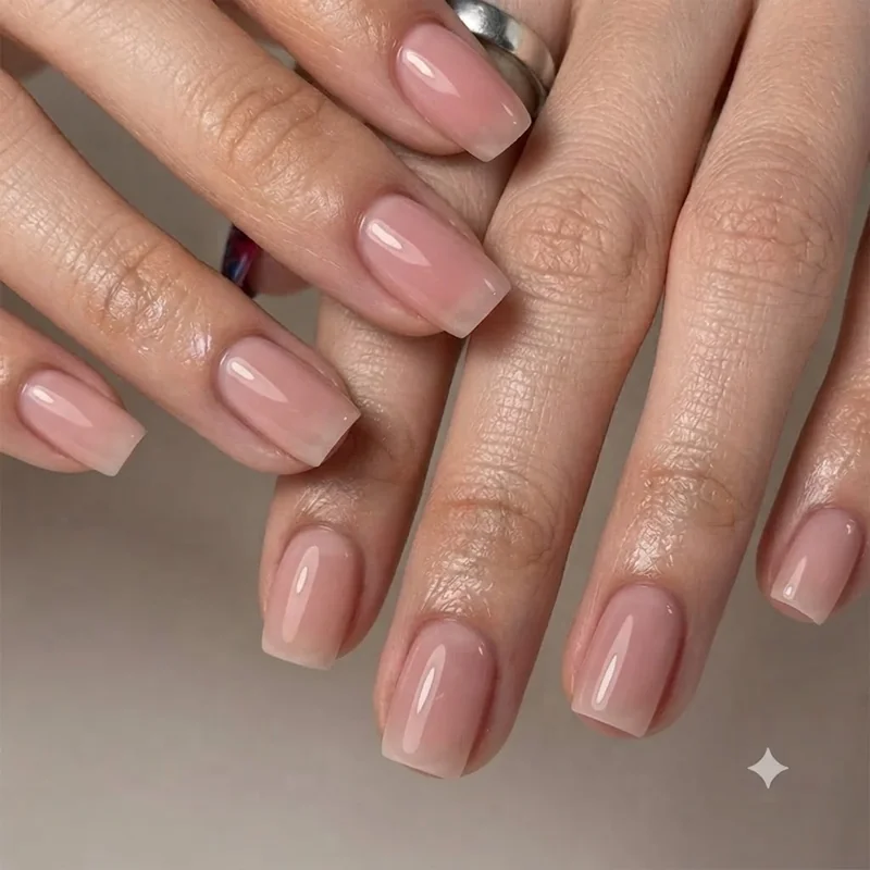 90s nail trends short square manicure with sheer pink polish and glossy finish
