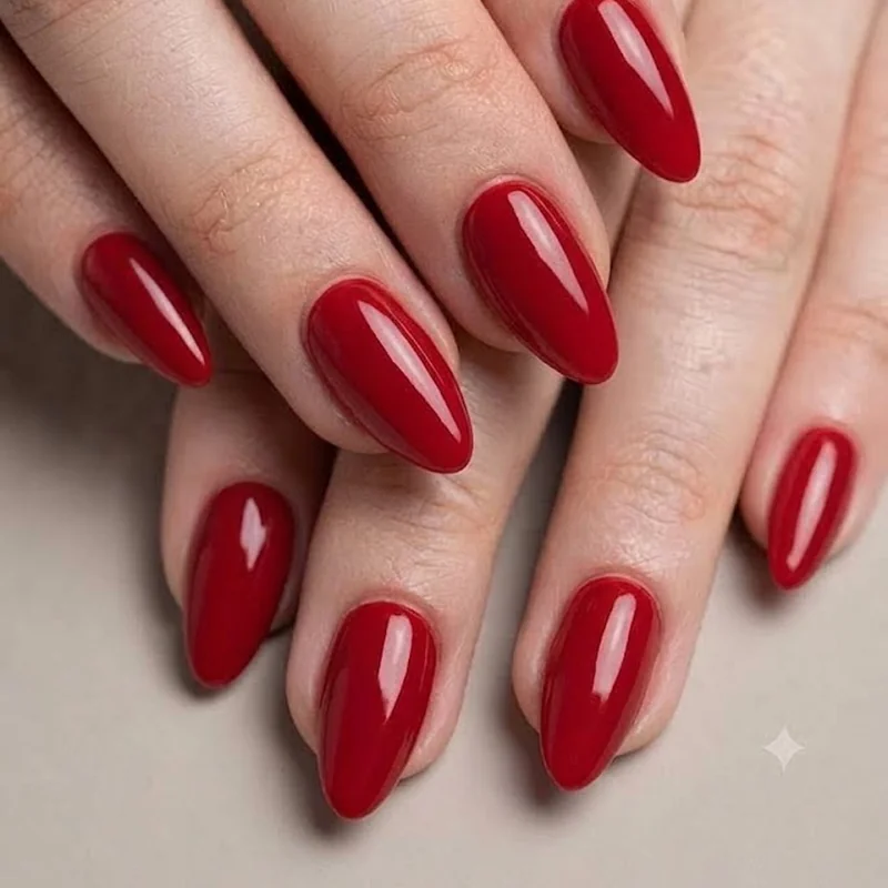 Classic red glossy hoco nails in almond shape for a bold homecoming look