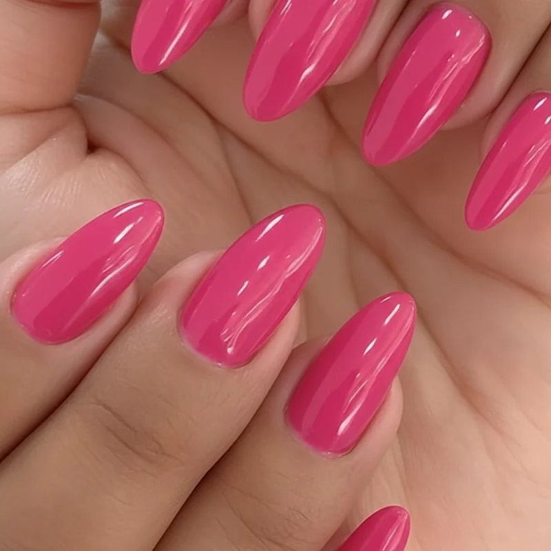 Deep dark skin wearing vibrant hot pink summer manicure demonstrating high colour contrast saturation and luminous finish