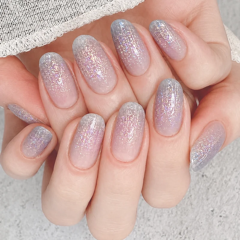 Glitter fade ombre nail showing sponge patting fine gold glitter onto nail tip over nude base creating natural gradient fade