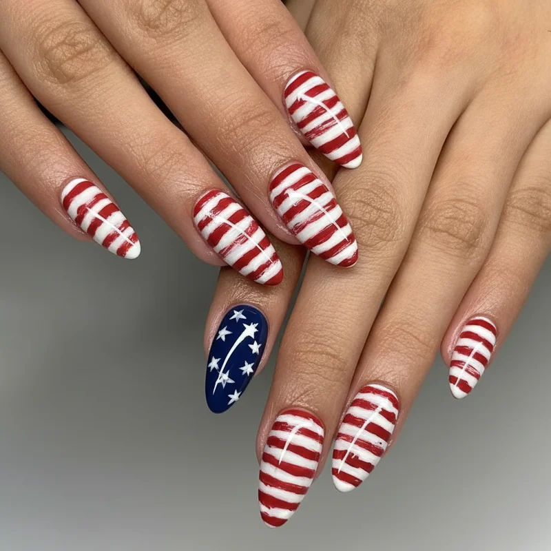 Fourth of july nails featuring an abstract flag accent nail with fine red stripes