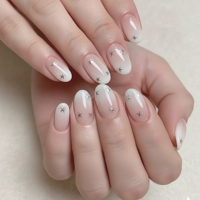 Subtle 4th of july nails with milky white base and scattered tiny neutral stars