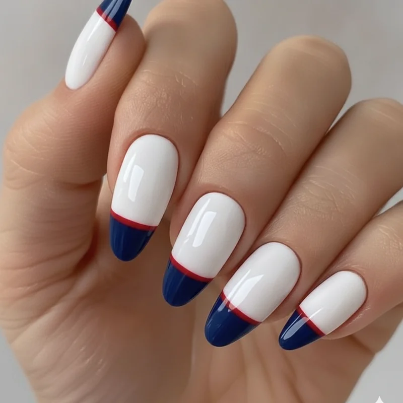 Patriotic nails with a navy french tip and thin red line on coffin shaped nails