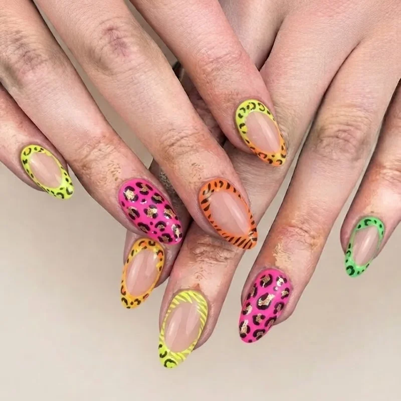 Animal print and neon Y2K concert nails featuring bold leopard print nail art with bright glow polish color combinations