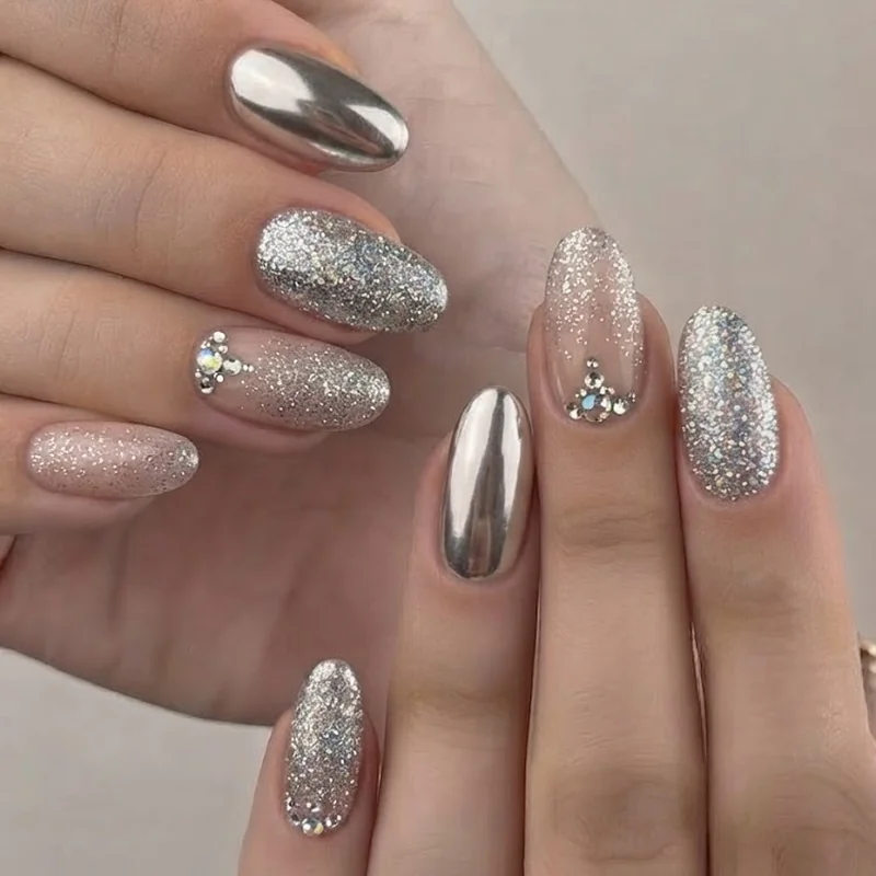 Finished concert ready manicure set styled for a night out at a Kesha show featuring glitter, chrome polish, and gemstones