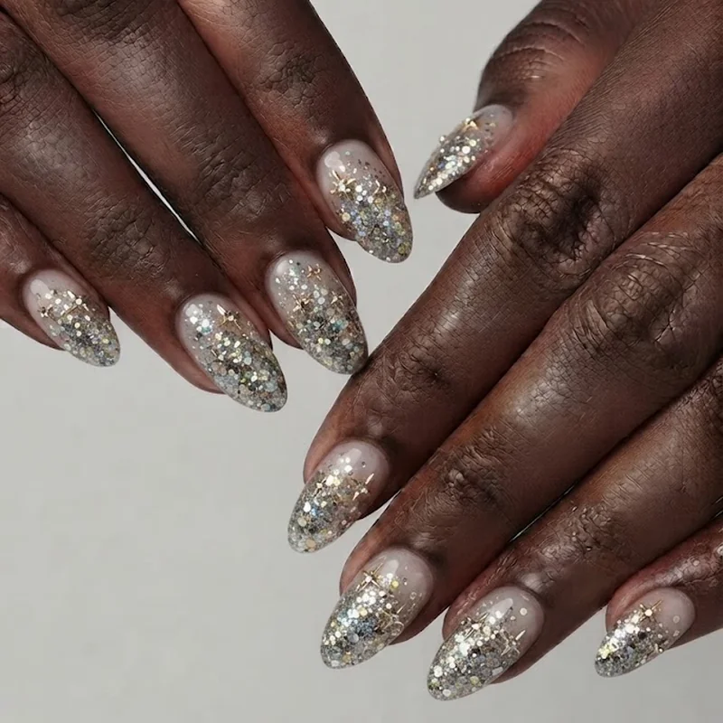 Kesha concert nails glitter gradient chaos manicure with chunky loose glitter and rhinestone star accents for concert shows