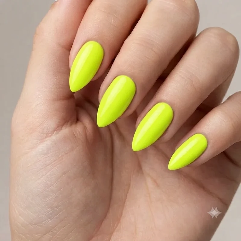 Neon green lime stiletto nail set in fluorescent finish on long tapered nail shape