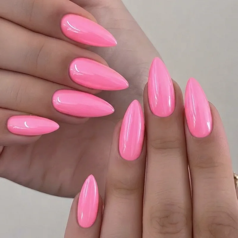 Full hand shot of neon pink chrome stiletto nail set showing sharp tapered tip shape
