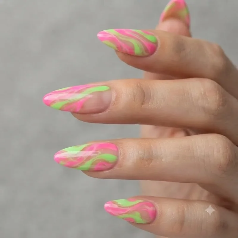 Press on neon stiletto nails styled for at home application in fluorescent pink and green