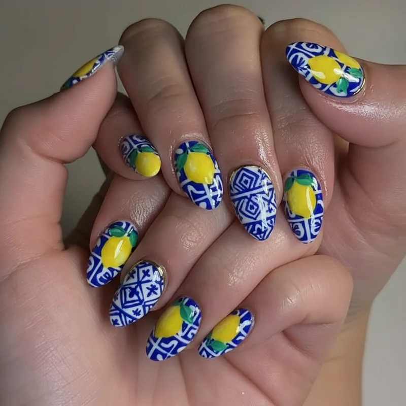 Amalfi Coast lemon nail art set featuring hand painted lemons with majolica blue tile detailing on almond shaped nails 2026