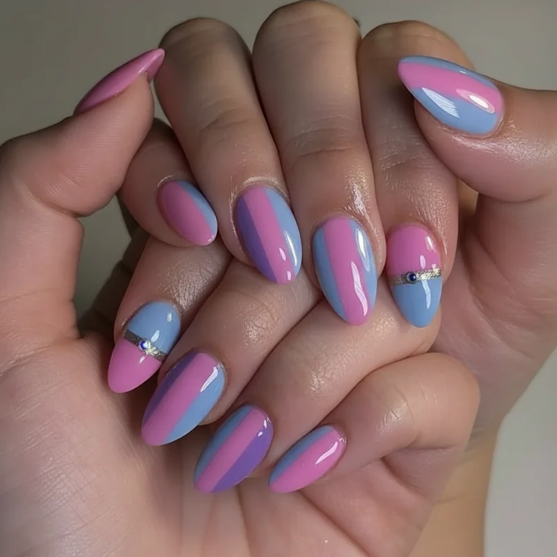 Short almond bi nails in pink purple and blue on compact taper shape showing bisexual pride designs on shorter nail lengths
