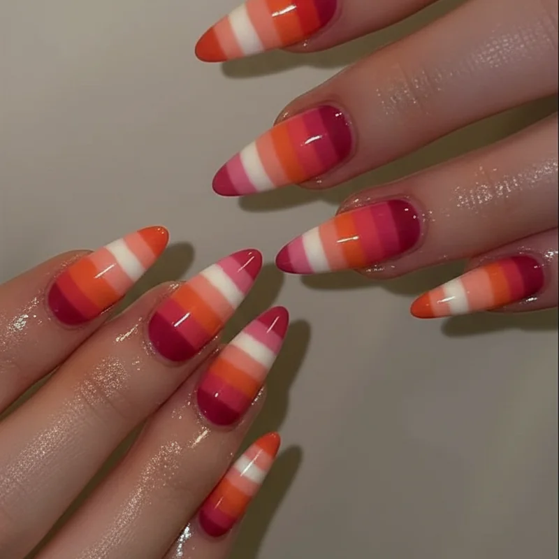 Queer manicure showing two short nails on dominant hand with longer nails on remaining fingers as WLW identity signal