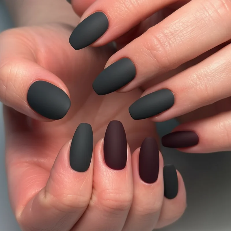Stud nail designs showing dark solid matte base with single accent finger for butch WLW aesthetic inspired by TikTok stud community