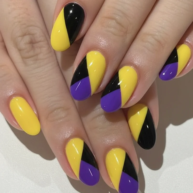 Geometric enby nail art featuring colour blocked diagonal split design in yellow purple and black on short square nails queer androgynous aesthetic