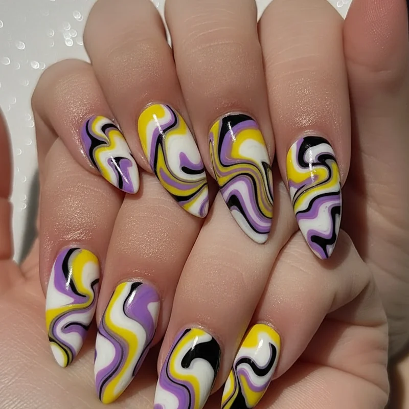 Watermarble nonbinary nail art close up showing yellow white purple and black fluid marble pattern created with toothpick on almond shaped nails
