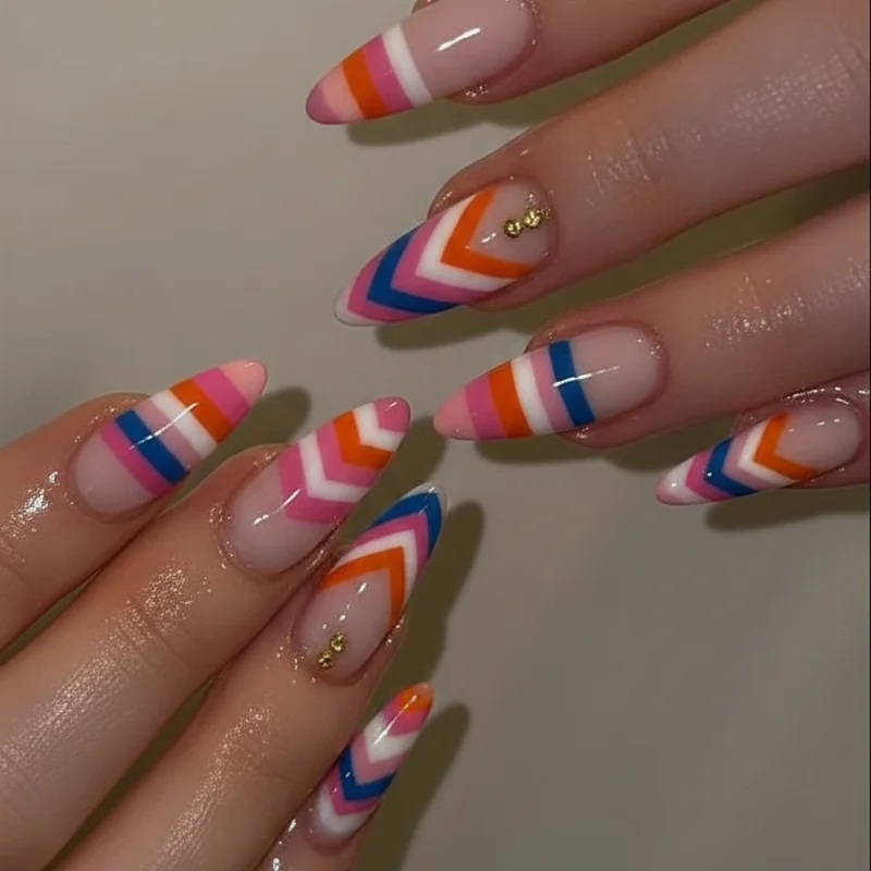 LGBTQ pride flag nail art showing identity visibility with orange pink blue chevron stripe designs across multiple fingers