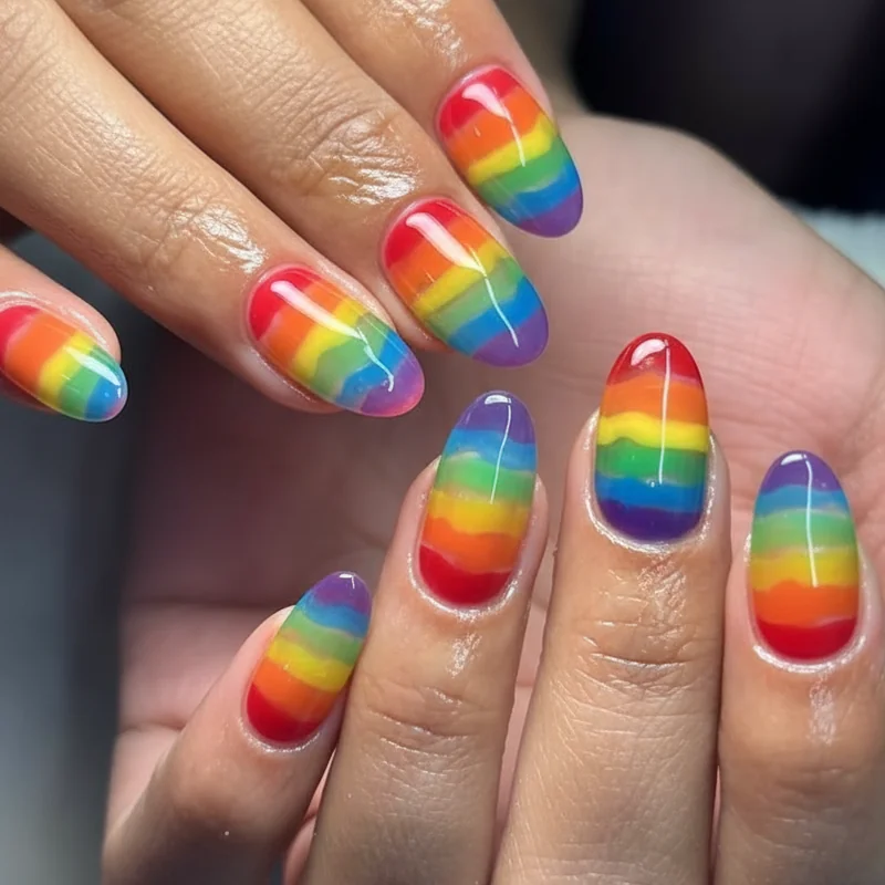 Jelly nails in pride colours showing translucent rainbow LGBTQ layered glass finish with buildable opacity for June 2026 pride manicure
