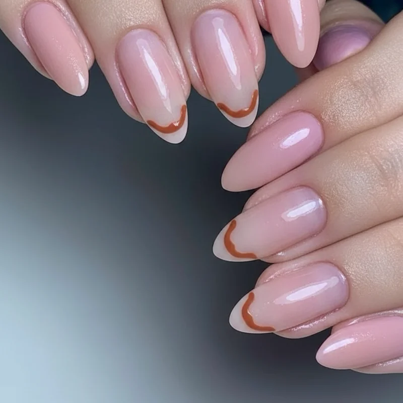 Negative space minimalist queer nail art showing cuticle arc in orange on sheer base close up subtle lesbian identity design