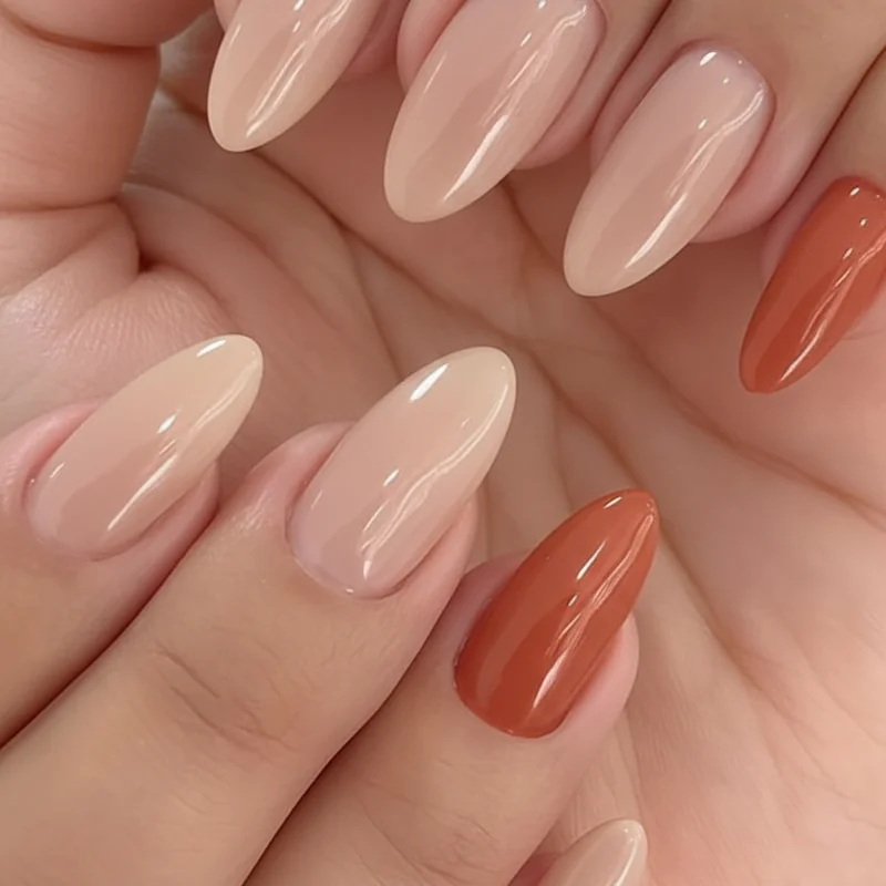 Work safe subtle lesbian nails for conservative office showing nude base with muted orange accent nail professional minimalist WLW manicure