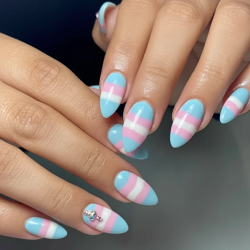 Coffin almond and stiletto trans pride acrylic nail shapes comparison showing blue pink white palette across three different silhouettes