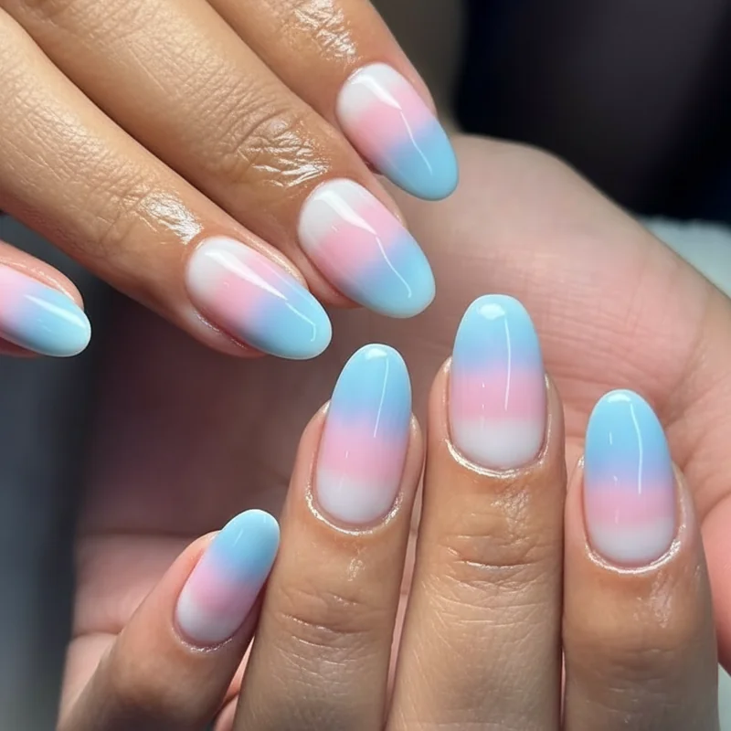 Trans flag ombre acrylic nails showing wet blend gradient from white base through soft pink to baby blue tip in 2026 design