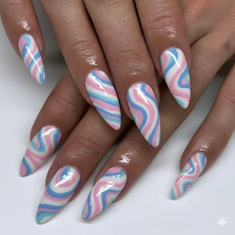 Trans flag swirl nail art showing curved blue pink and white graphic lines over white base using fine striping brush technique on long almond nails