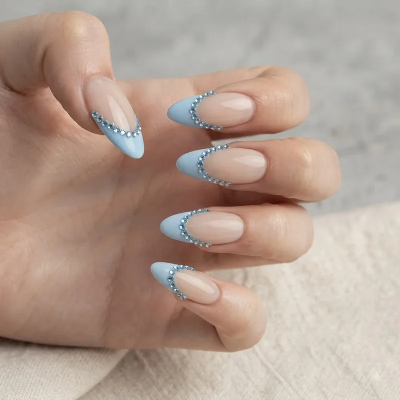Light blue rhinestone French tip nail design styled for prom and homecoming occasion manicures