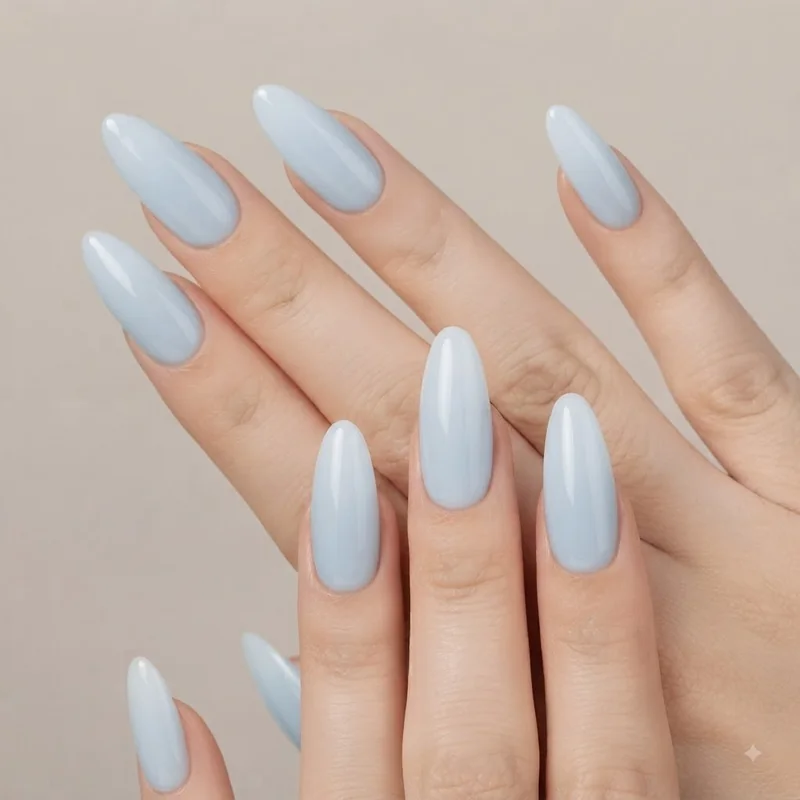 Solid glossy light blue nail polish in a minimalist milky manicure style for everyday wear