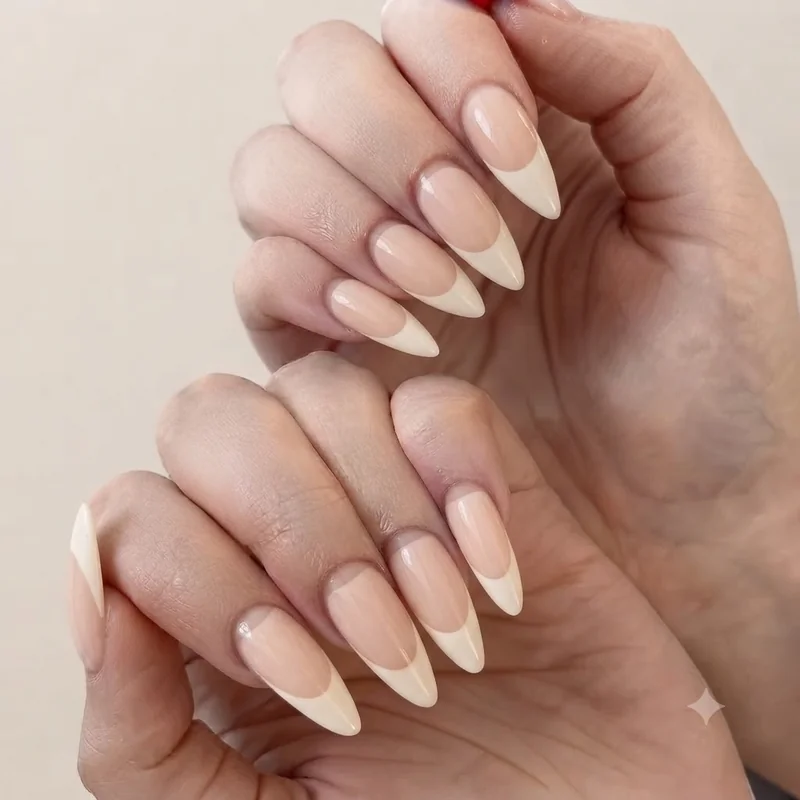 Negative space French tip manicure with sheer nude base and bare gap detail