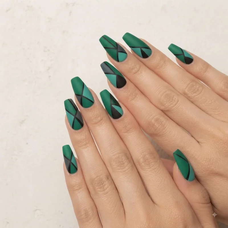 Bold matte emerald green manicure with color-blocked design, editorial nail styling