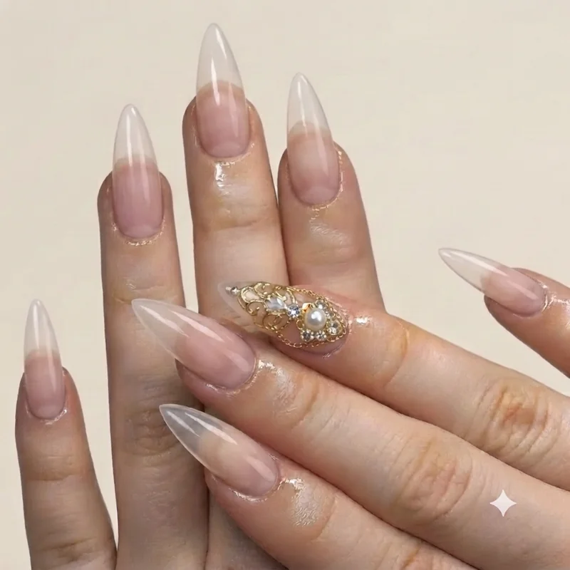 Maximalist nails featuring 3D gel charms and rhinestone gems on accent nail with gold detailing