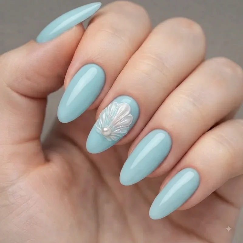 Mermaid nail designs featuring 3D sculpted shell and pearl accent detail on a single statement nail
